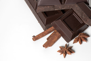 Pieces of Chocolate and cinnamon isolated on white background