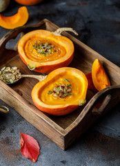 Pumpkin soup in pumpkin. Vegetarian autumn pumpkin cream soup with seeds.