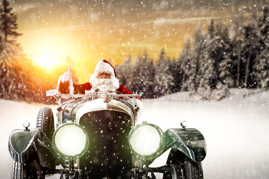 Red old Santa Claus in green retro car and free space for your decoration. 