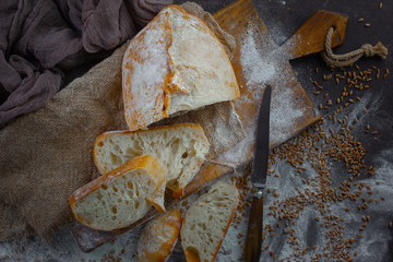 Bread in a composition with kitchen accessories on an old background