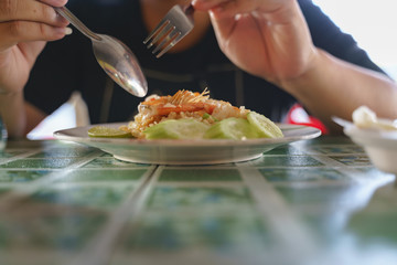 Eating stir fried rice with shrimp or prawn