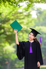 Asian female standing with diploma