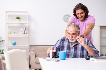 Young student and his old grandpa at home