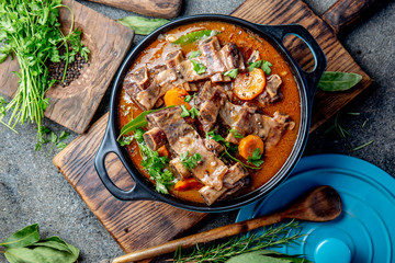 Beef ribs Bourguignon. Beef ribs stewed with carrot, onion in red wine. France dish. Top view