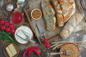 Bread in a composition with kitchen accessories on an old background