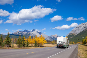An RV aon the highway through the Canadian Rocky Mountains in Kananaskis, Alberta, Canada during...