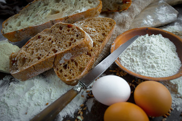 Bread in a composition with kitchen accessories on an old background