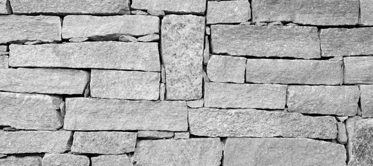 Hintergrund abstrakt Steine Steinmauer Mauer in schwarz und weiß und grau