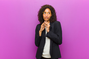 young black business woman scheming and conspiring, thinking devious tricks and cheats, cunning and...