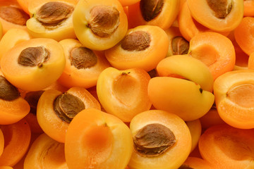 Ripe juicy orange apricots slices fruit background.