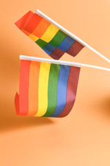 LGBT flag on orange background. Copy space.