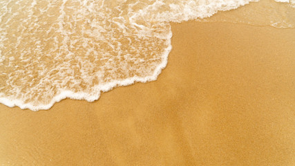 Fototapeta na wymiar waves on a sandy beach
