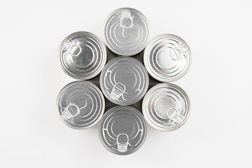 Group of silver canned food on white background.