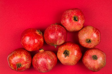 Sweet pomegranate on red background.