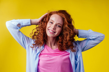 good mood concept. happy snow white smile redhead ginger woman feeling endorphins and love posing in studio over yellow background