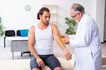 Fototapeta premium Young male patient visiting experienced doctor