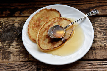 pancakes with honey and a silver spoon