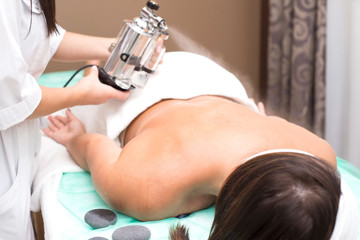 Zaporozhye, Ukraine. September 15, 2019. Beauty salon Prima Vera A cosmetologist doctor applies essential oils to the skin of a young woman. Relaxing treatments. Tanning. Spa treatments with Lucas