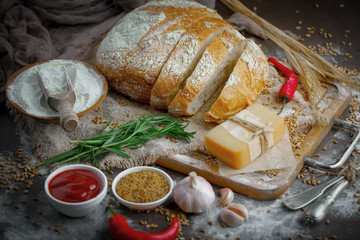 Bread in a composition with kitchen accessories on an old background