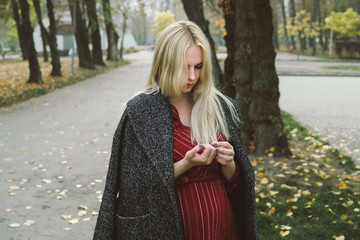 young beautiful pregnant woman in a red dress