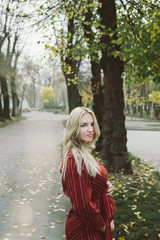 young beautiful pregnant woman in a red dress