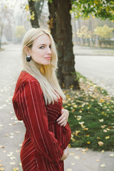 young beautiful pregnant woman in a red dress