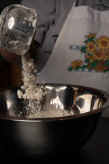 Flour being added to a bowl while cooking