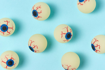Halloween pattern eyeballs on a pastel blue background.