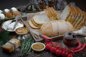 Bread in a composition with kitchen accessories on an old background