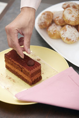 Woman confectioner preparing cake