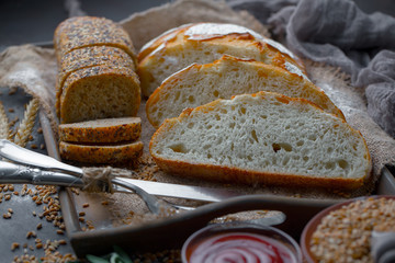 Bread in a composition with kitchen accessories on an old background