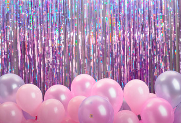 Pink and purple balloons on colorful background.