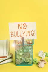 Conceptual hand writing showing No Bullying. Concept meaning stop aggressive behavior among children power imbalance Trash bin crumpled paper clothespin office supplies yellow