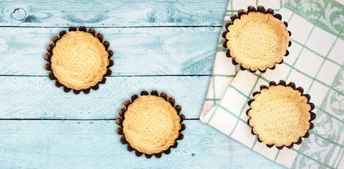 Empty Tartlets or pie isolated on wood table