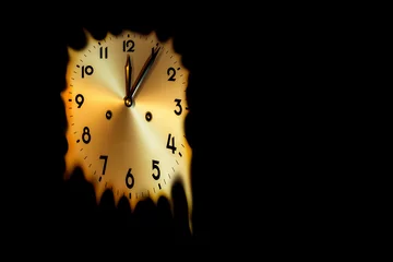 Fotobehang mechanical clock face that melts at five minutes past midnight time on a black background copy space © PT pictures