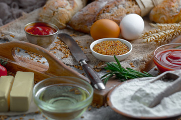 Bread in a composition with kitchen accessories on an old background