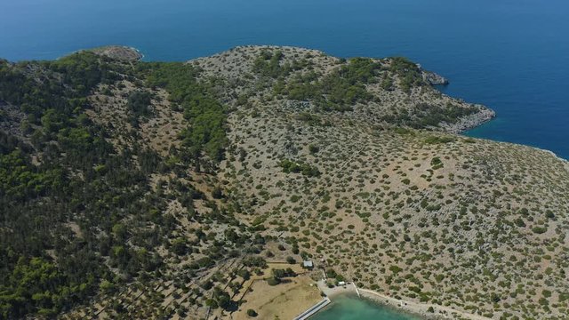 Aerial drone panoramic view video of famous exotic paradise island with mountains and Bay Simi panormitis