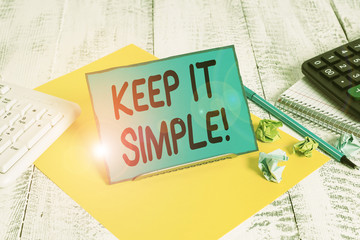 Conceptual hand writing showing Keep It Simple. Concept meaning ask something easy understand not go into too much detail Notepaper on wire in between computer keyboard and sheets