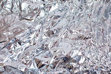 Abstract crumpled silver aluminum foil closeup background