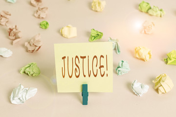 Writing note showing Justice. Business concept for impartial adjustment of conflicting claims or assignments Colored crumpled papers empty reminder pink floor background clothespin