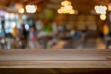 A wooden table on a restaurant blurred background