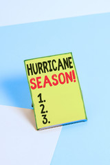 Word writing text Hurricane Season. Business photo showcasing time when most tropical cyclones are expected to develop Paper placed tilted above buffer wire on soft pastel multi colours backdrop