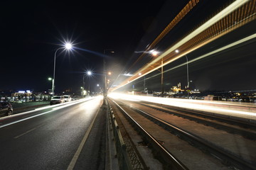 Fototapeta na wymiar Blurred motion lights in road at night