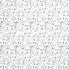 Small uneven spots and particles of debris. Abstract vector texture.  Distressed uneven background. Grunge texture overlay with fine grains isolated on white background. Vector illustration. EPS10.