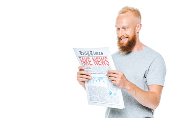 cheerful man reading newspaper with fake news, isolated on white