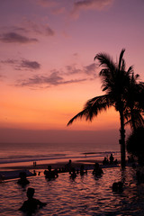 Fototapeta na wymiar Sunset in Bali over the ocean with reflexion