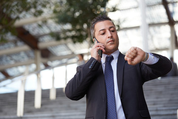 businessman talking to mobile in urban environment