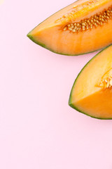 Ripe melon isolated on light pink background. 