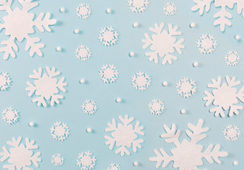 Christmas pattern made of snowflakes on blue background. Christmas concept. Flat lay, top view