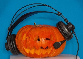 Cute festive orange pumpkin for Halloween on a blue plain background